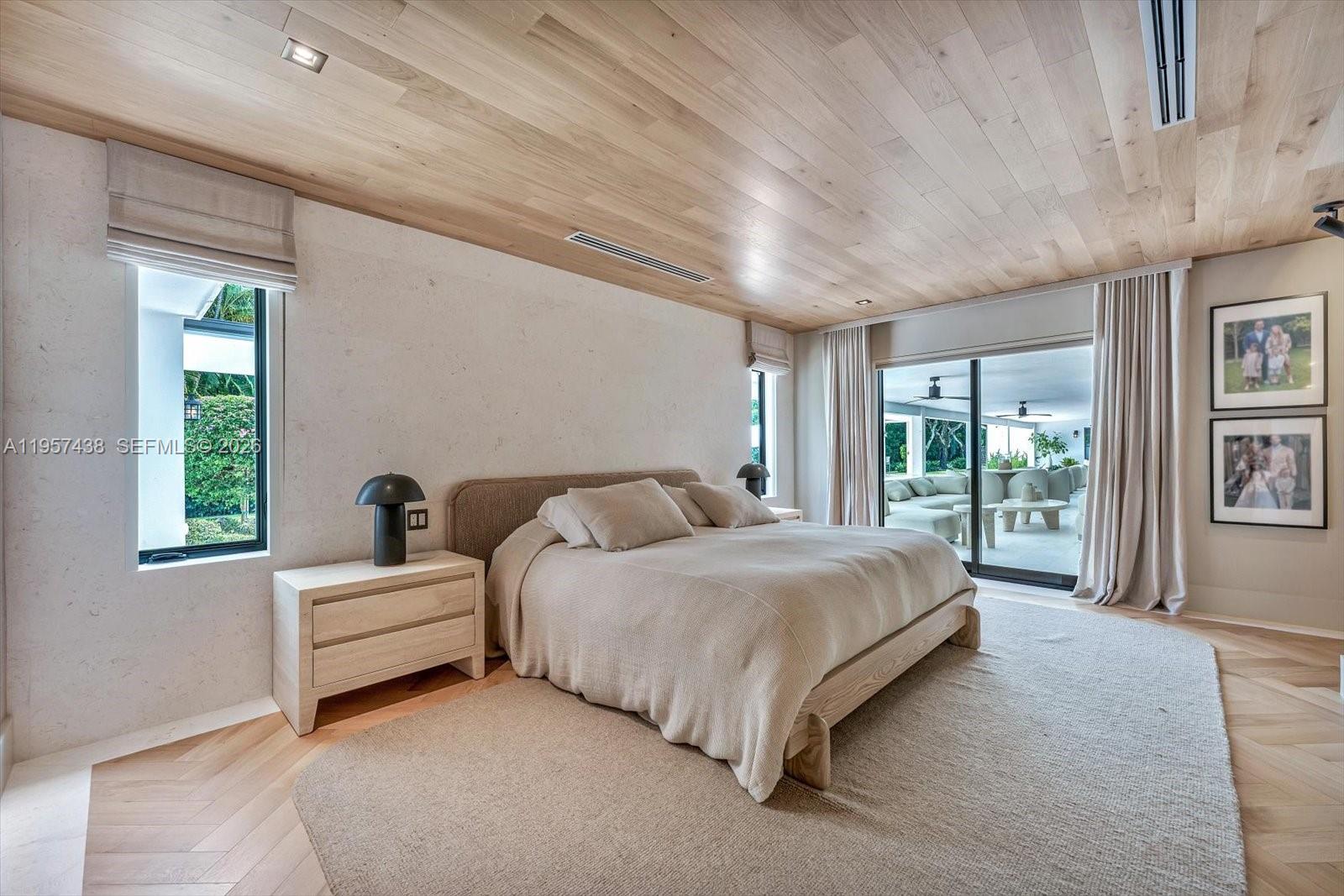 5902 Southwest 105th Street Pinecrest, FL 33156 - Photo 21 of 30 a spacious bedroom with a bed and large windows