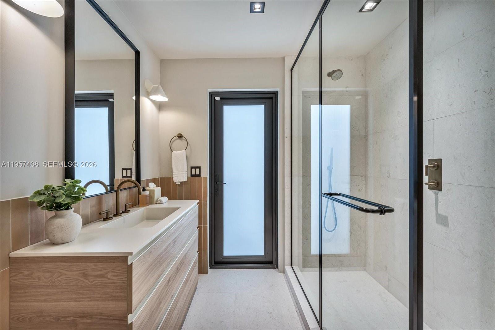 5902 Southwest 105th Street Pinecrest, FL 33156 - Photo 22 of 30 a bathroom with a double vanity sink mirror and double