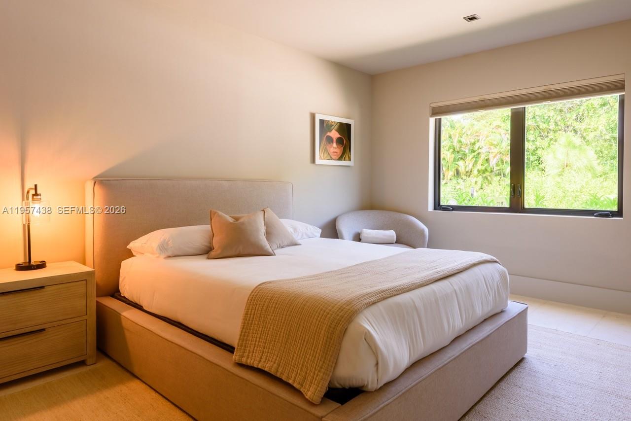 5902 Southwest 105th Street Pinecrest, FL 33156 - Photo 26 of 31 a bedroom with a bed and window