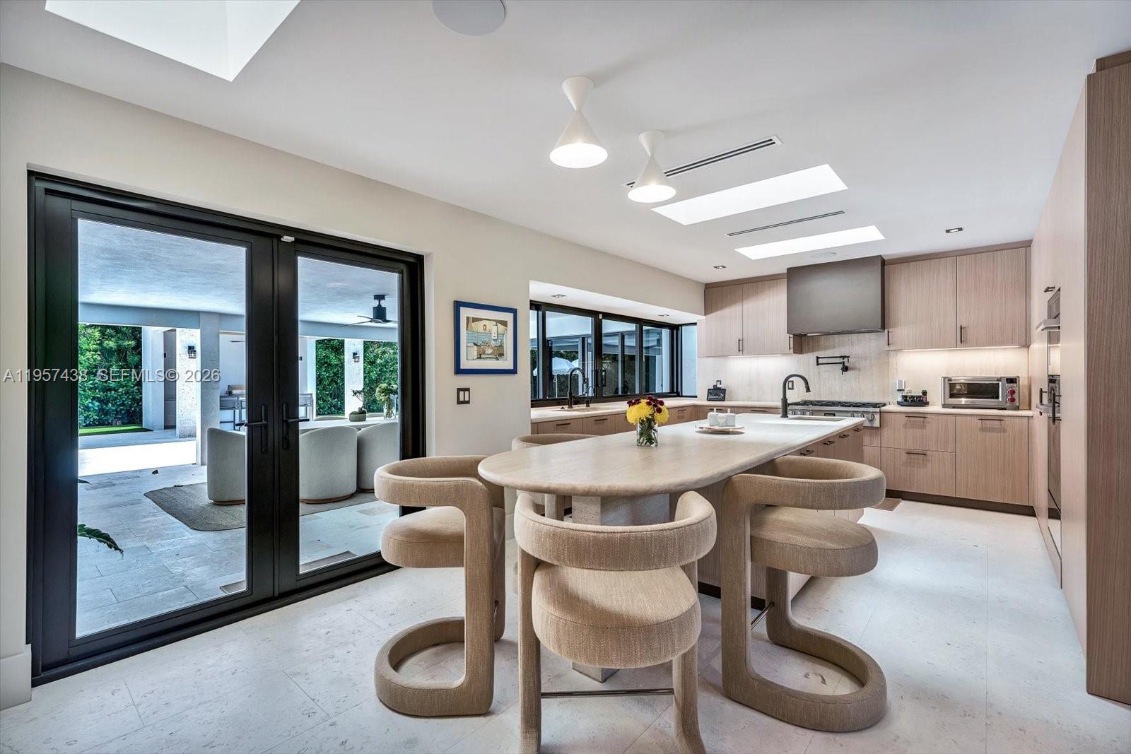 5902 Southwest 105th Street Pinecrest, FL 33156 - Photo 6 of 30 a view of a dining room kitchen and hall with wooden floor