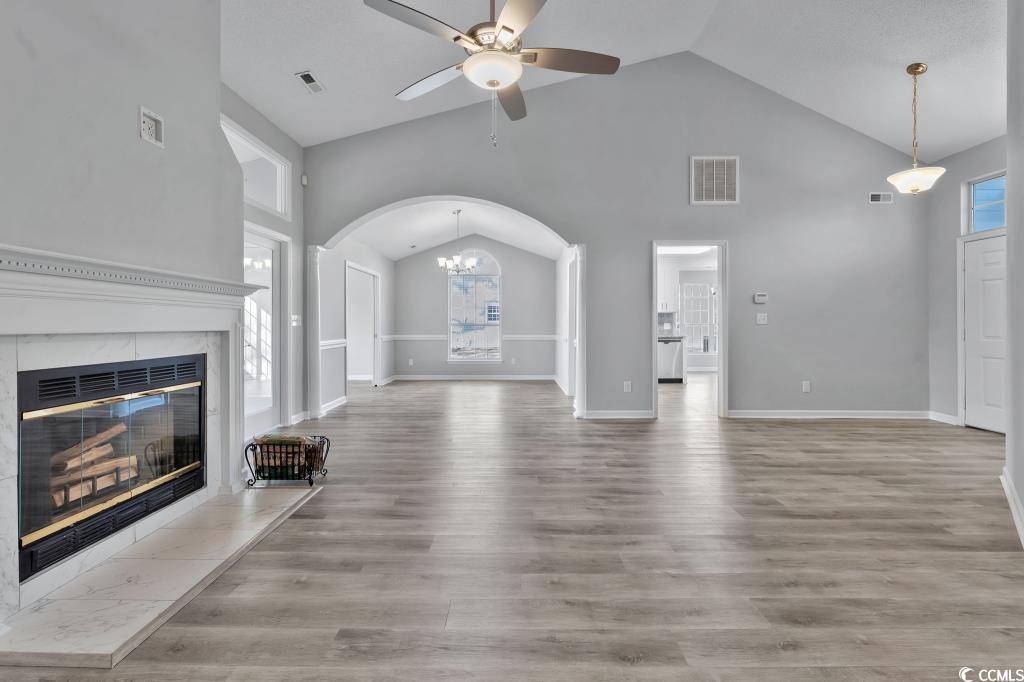 1639 Coventry Road Surfside Beach, SC 29575 - Photo 36 of 38 Unfurnished living room with hardwood / wood-style flooring, a fireplace, high vaulted ceiling, and ceiling fan