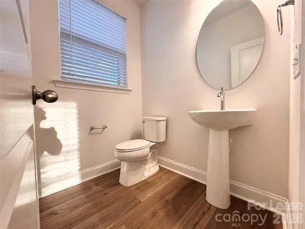 a bathroom with a toilet and a mirror
