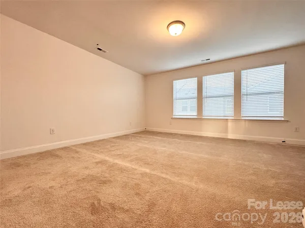 an empty room with a empty space and windows