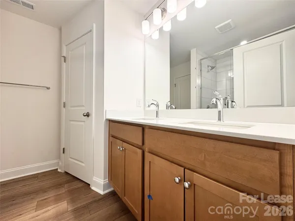 a bathroom with a double vanity sink and mirror