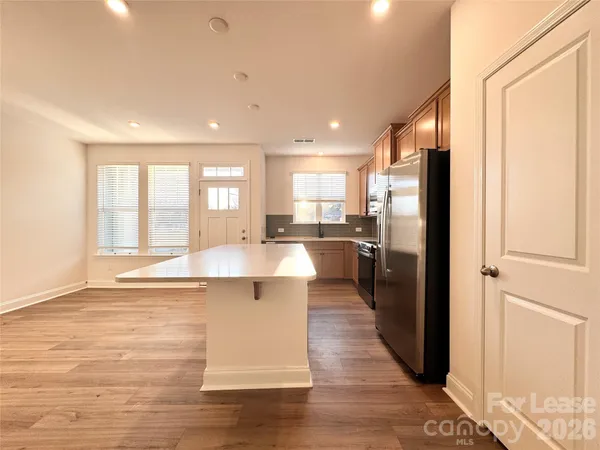 a large kitchen with a large window and stainless steel appliances