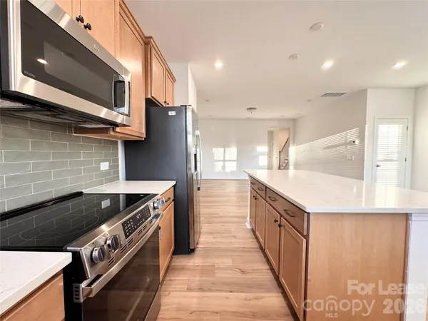 a kitchen with stainless steel appliances granite countertop a stove and a sink