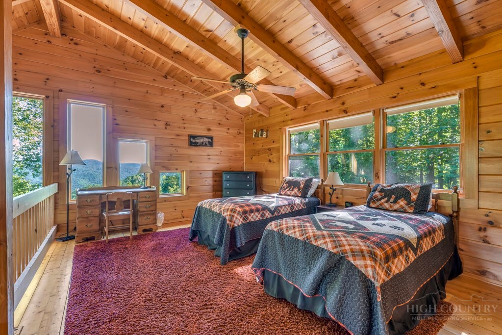 2229 Elk Ridge Road Ferguson, NC 28624 - Photo 25 of 42 a bedroom with a bed a large window with table and chairs