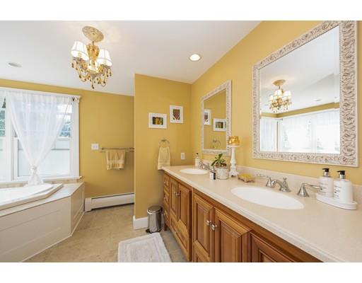 32 Bennett Road Marblehead, MA 01945 - Photo 16 of 24 a bathroom with a granite countertop sink a large mirror a bathtub and next to a window