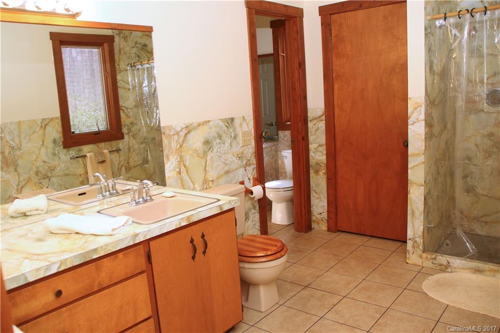 5608 Davis Road, Unit 20 Waxhaw, NC 28173 - Photo 16 of 21 a bathroom with a granite countertop sink toilet and shower