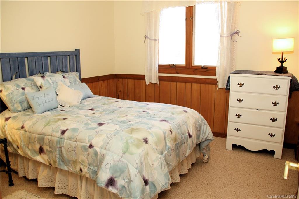 5608 Davis Road, Unit 20 Waxhaw, NC 28173 - Photo 17 of 21 a bed sitting in a bedroom next to a window with dresser
