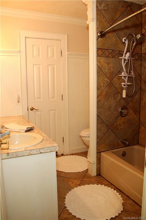 5608 Davis Road, Unit 20 Waxhaw, NC 28173 - Photo 18 of 21 a bathroom with a granite countertop sink toilet and shower