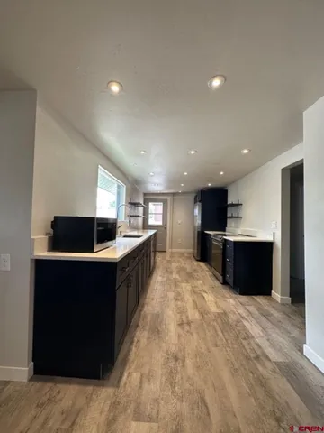a living room with stainless steel appliances kitchen island furniture and a kitchen view