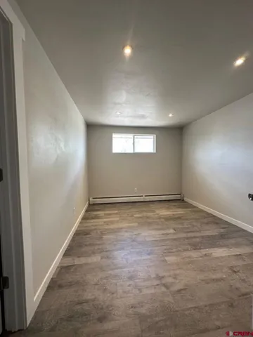 an empty room with a empty space and windows