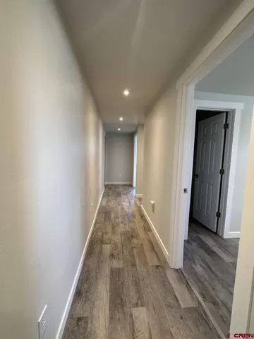 a view of hallway with wooden floor