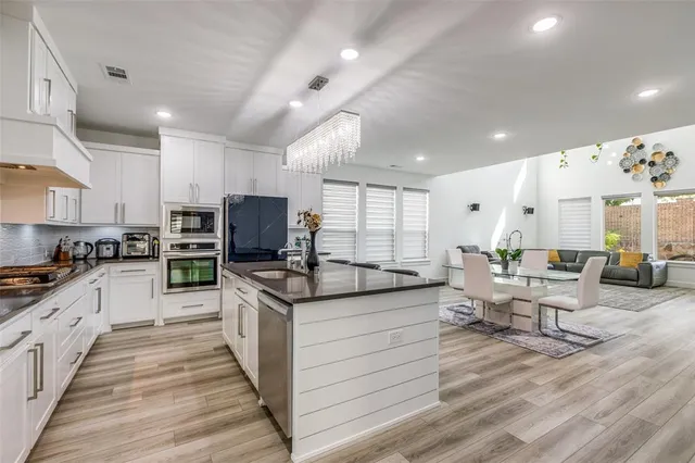 a kitchen with stainless steel appliances granite countertop a sink and cabinets
