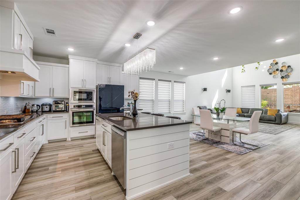 a kitchen with stainless steel appliances granite countertop a sink and cabinets