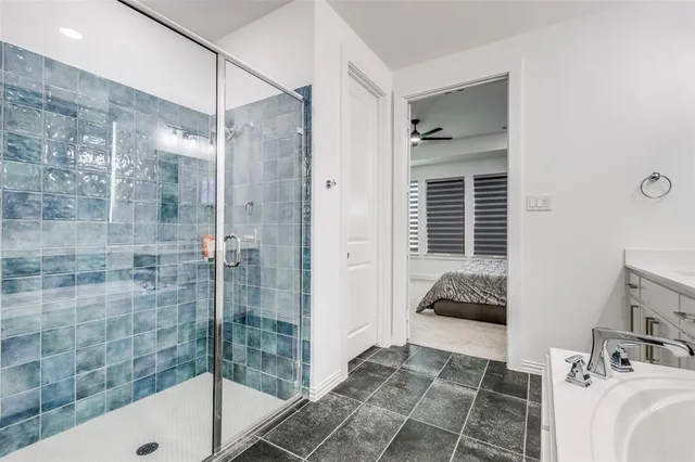 a bathroom with a bathtub and a shower