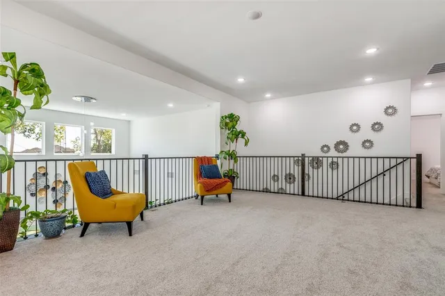 a living room with furniture and stairs