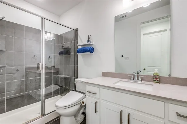 a bathroom with a sink toilet and shower