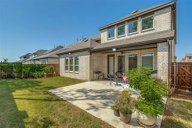 a front view of a house with a garden and patio