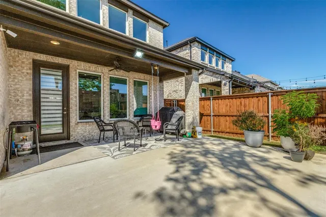 a view of a house with backyard porch and sitting area