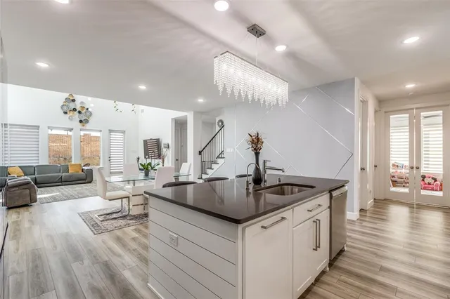 a kitchen with stainless steel appliances granite countertop a lot of living room and couches