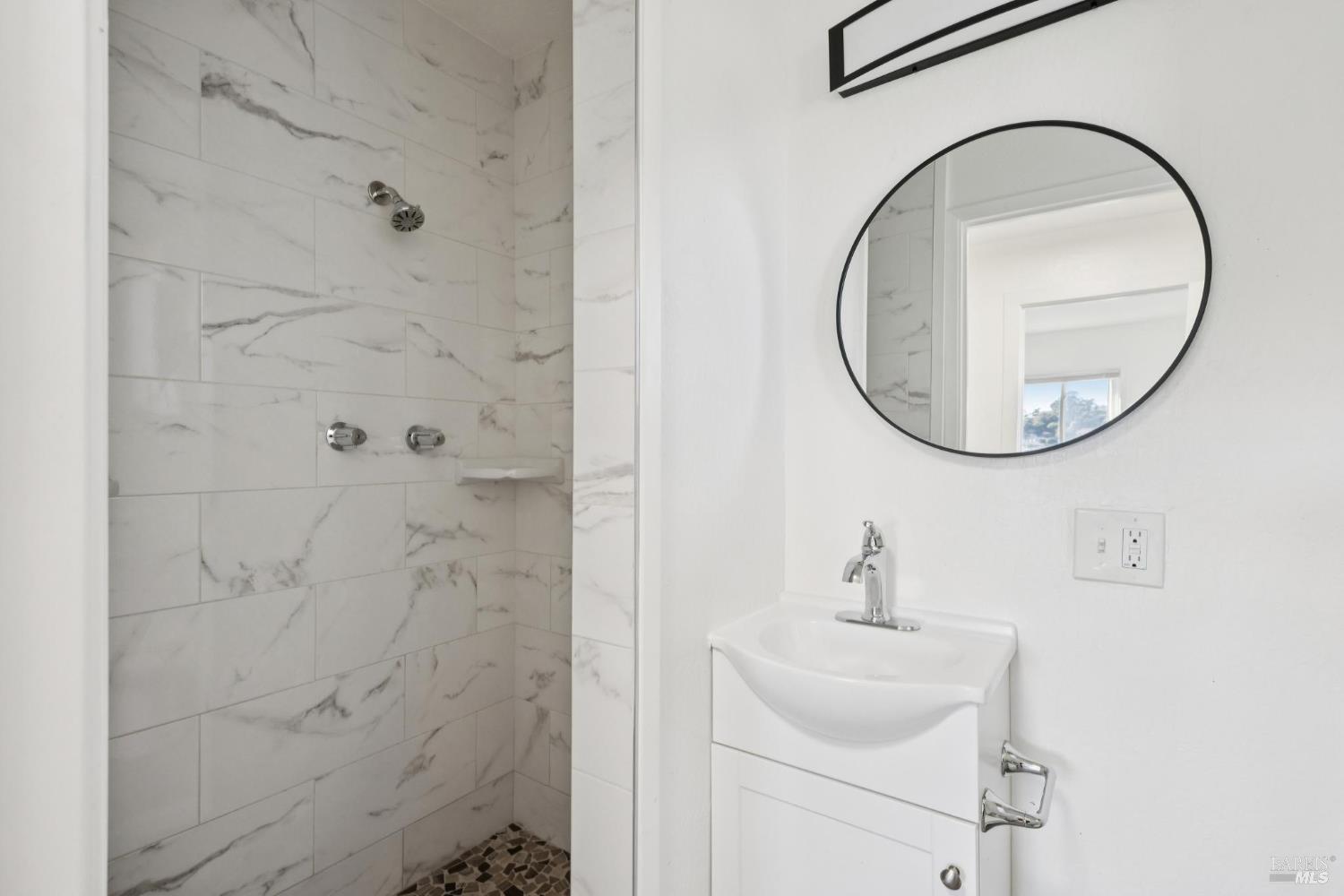 16 Dutton Court Sausalito, CA 94965 - Photo 34 of 42 a bathroom with a sink and a mirror