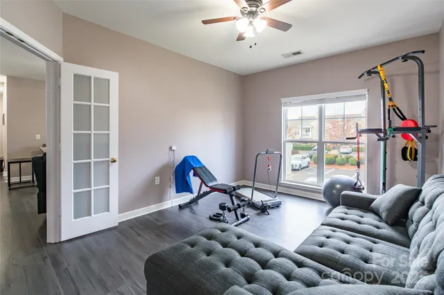a living room with furniture chandelier and a large window