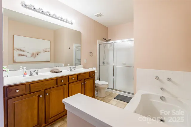 a bathroom with a tub sink and mirror