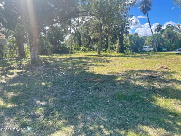 a view of outdoor space with trees all around