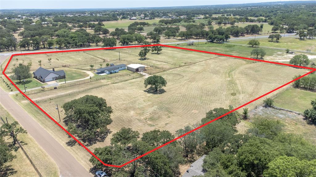 151 County Road 3699 Springtown, TX 76082 - Photo 33 of 35 Expansive land parcel featuring multiple structures, open fields, and established perimeter fencing