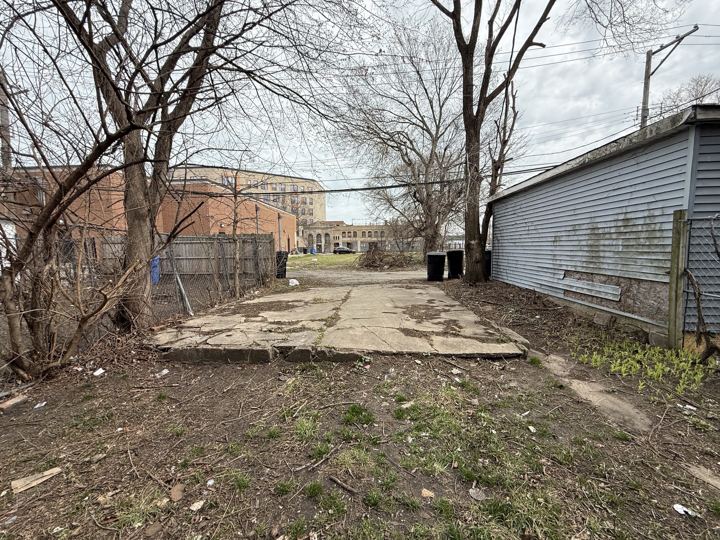7919 South Escanaba Avenue Chicago, IL 60617 - Photo 12 of 13 a backyard of a house with large trees and outdoor seating