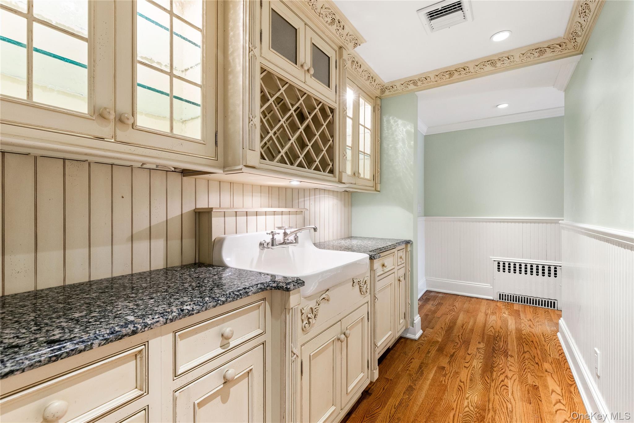 103 Pleasant Ridge Road Harrison, NY 10528 - Photo 14 of 39 Butler's pantry features beautiful cabinetry with illuminated glass insert cabinets, and essential dishwasher - back stairs up to bedrooms (not pictured)