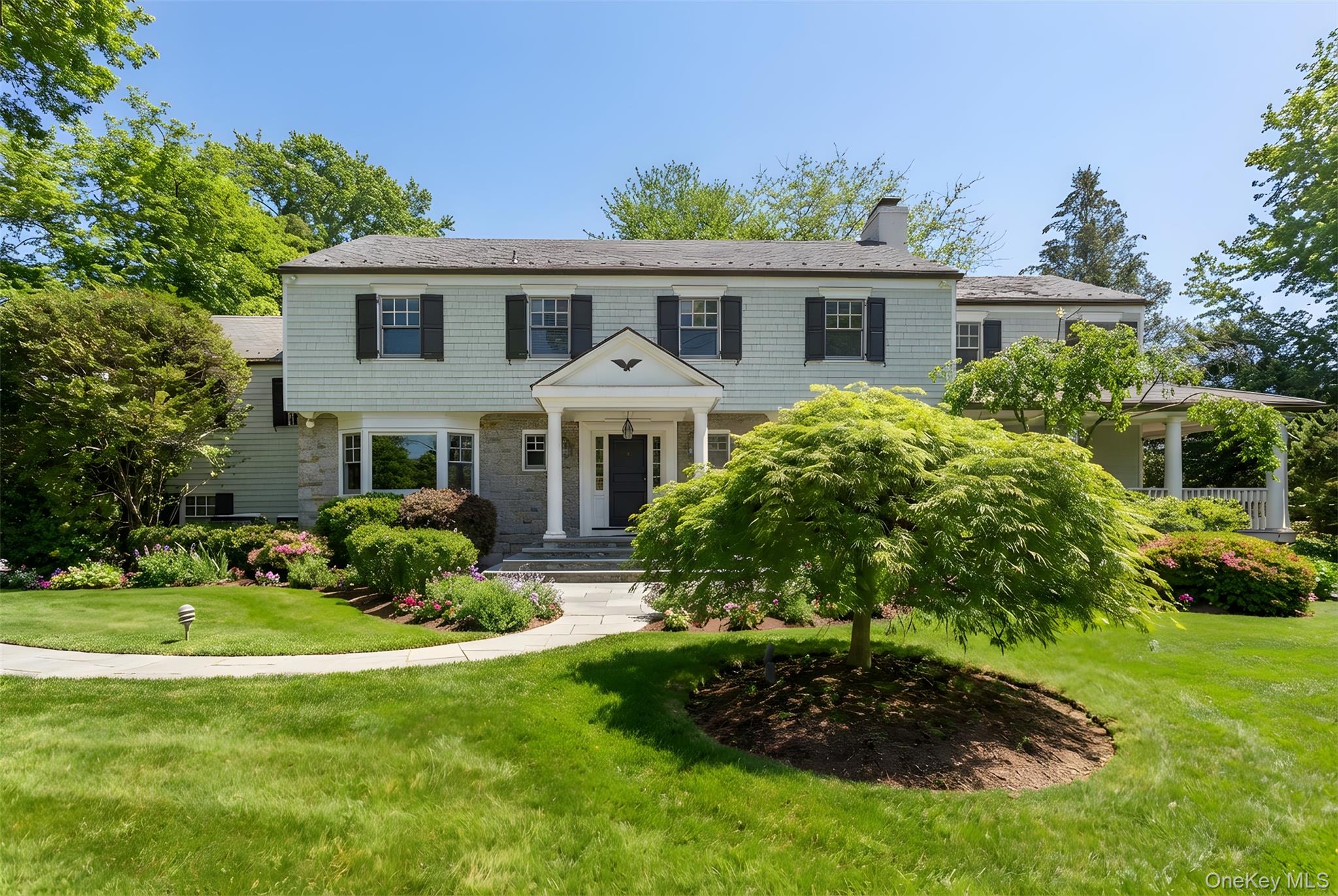 103 Pleasant Ridge Road Harrison, NY 10528 - Photo 2 of 39 Stately and serene, 103 Pleasant Ridge captivates from the street with its substantial stone wall, slate roof and copper gutter detailing