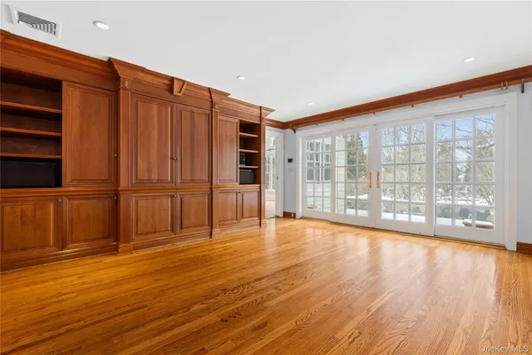 a large white kitchen with a stove a refrigerator and a fireplace