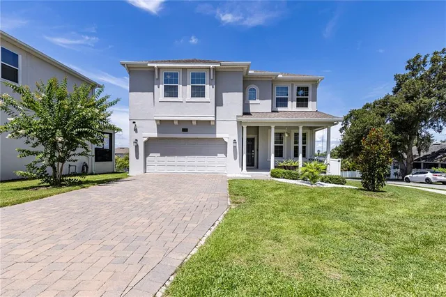 a front view of a house with garden and porch