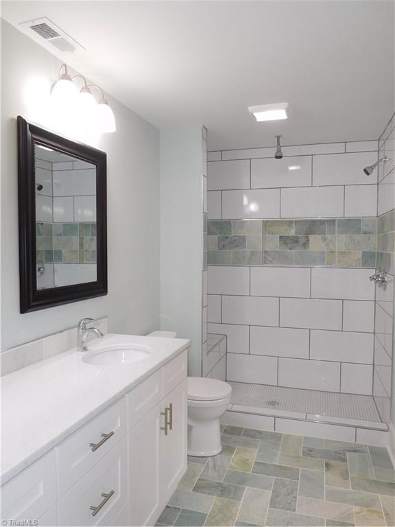 3545 Milhaven Road Winston-Salem, NC 27106 - Photo 15 of 30 Beautiful Master Bathroom. Tiled Floor, double sink vanity and walk-in tiled shower.