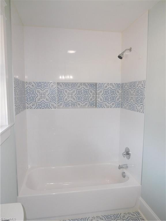 3545 Milhaven Road Winston-Salem, NC 27106 - Photo 19 of 30 All New Hall Bath. Tiled floor and bath/shower surround.