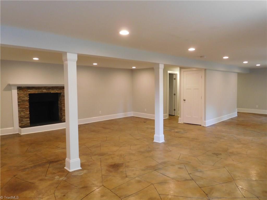 3545 Milhaven Road Winston-Salem, NC 27106 - Photo 24 of 30 Fireplace in Den. FP is being SOLD AS. Endless possibilites for this basement. Playroom, work out area, 2nd Den, home office.