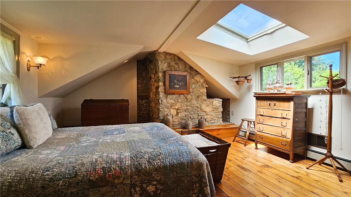 585 Buttermilk Road Hellertown, PA 18055 - Photo 27 of 82 Natural light floods this charming bedroom featuring exposed stone and original hardwood floors.