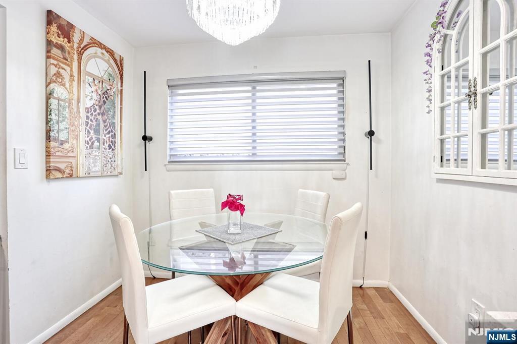 1110 River Road, Unit 105 Edgewater, NJ 07020 - Photo 11 of 19 a view of a dining room with furniture and wooden floor