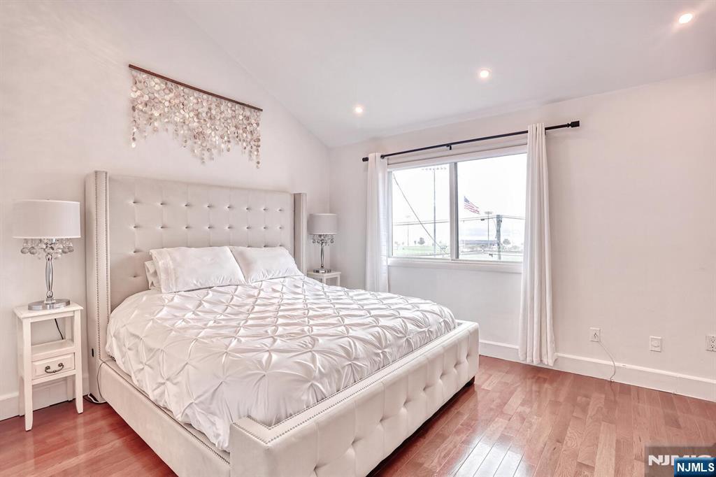 1110 River Road, Unit 105 Edgewater, NJ 07020 - Photo 12 of 19 a large bed sitting in a bedroom next to a window