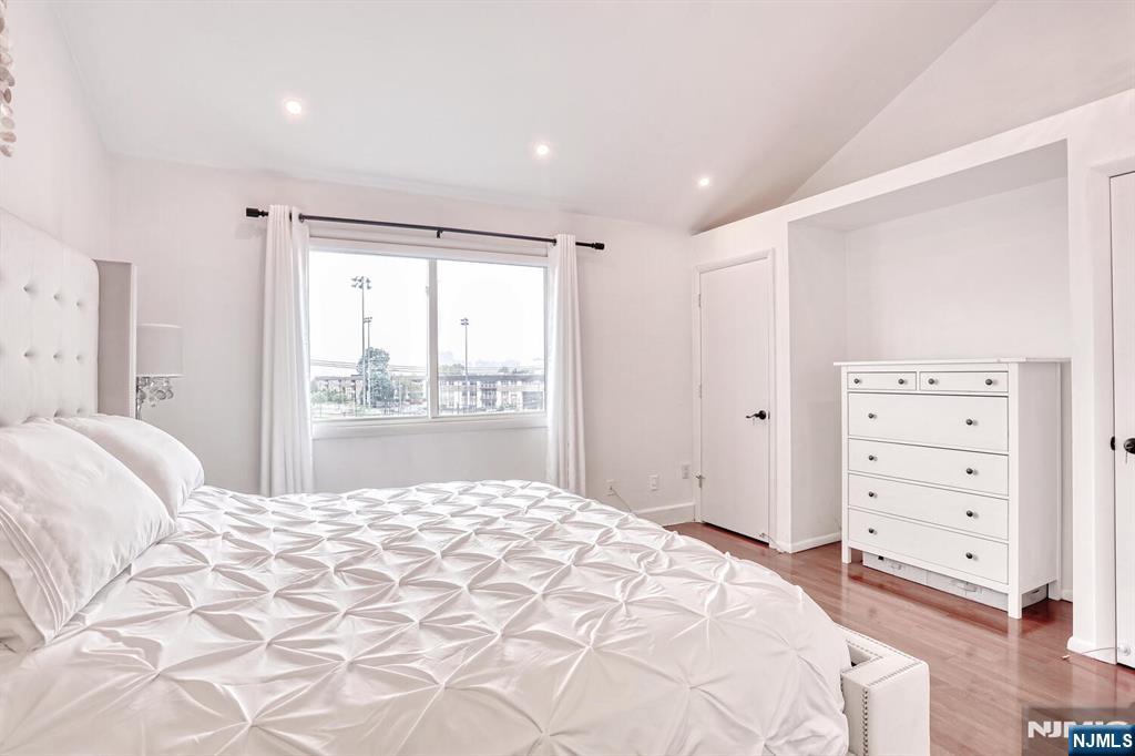 1110 River Road, Unit 105 Edgewater, NJ 07020 - Photo 13 of 19 a bedroom with a large bed and a window