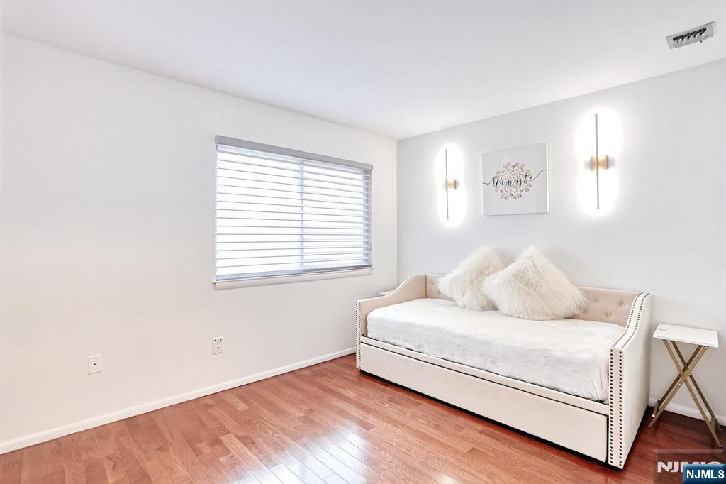 1110 River Road, Unit 105 Edgewater, NJ 07020 - Photo 16 of 19 a living room with a bed furniture and a window