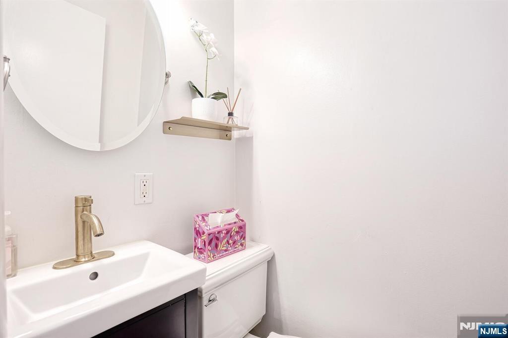 1110 River Road, Unit 105 Edgewater, NJ 07020 - Photo 17 of 19 a bathroom with a sink and a mirror