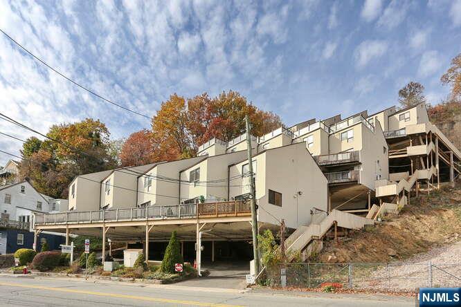 1110 River Road, Unit 105 Edgewater, NJ 07020 - Photo 19 of 19 a front view of a building with streets and trees
