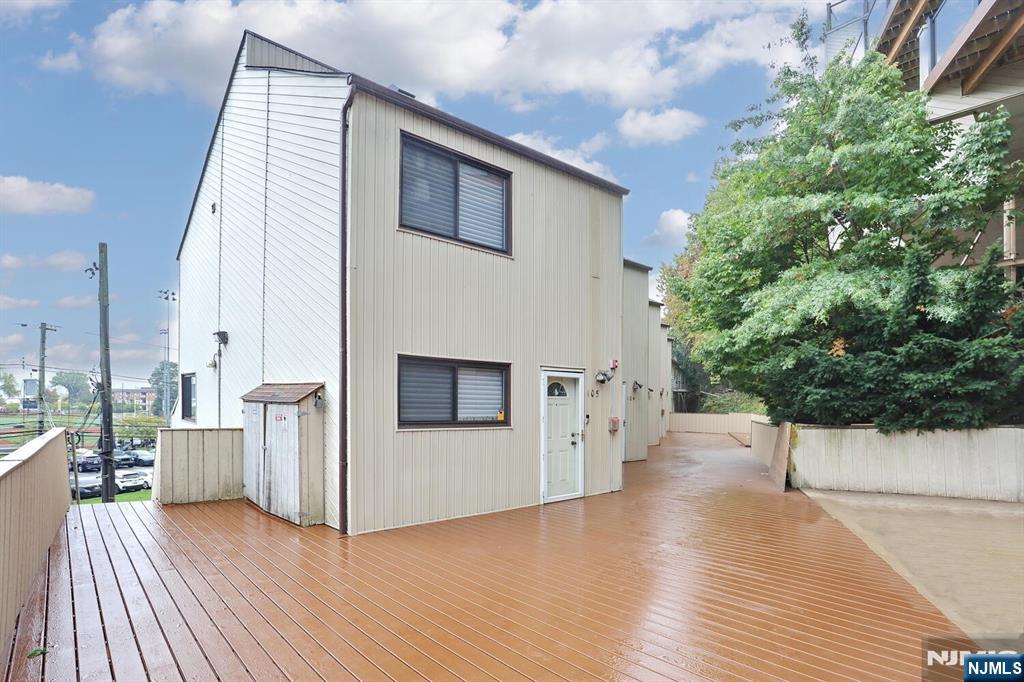 1110 River Road, Unit 105 Edgewater, NJ 07020 - Photo 2 of 19 a view of a porch with wooden floor and fence