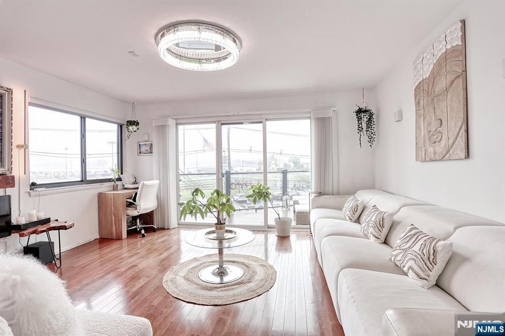 1110 River Road, Unit 105 Edgewater, NJ 07020 - Photo 5 of 19 a living room with furniture and a large window