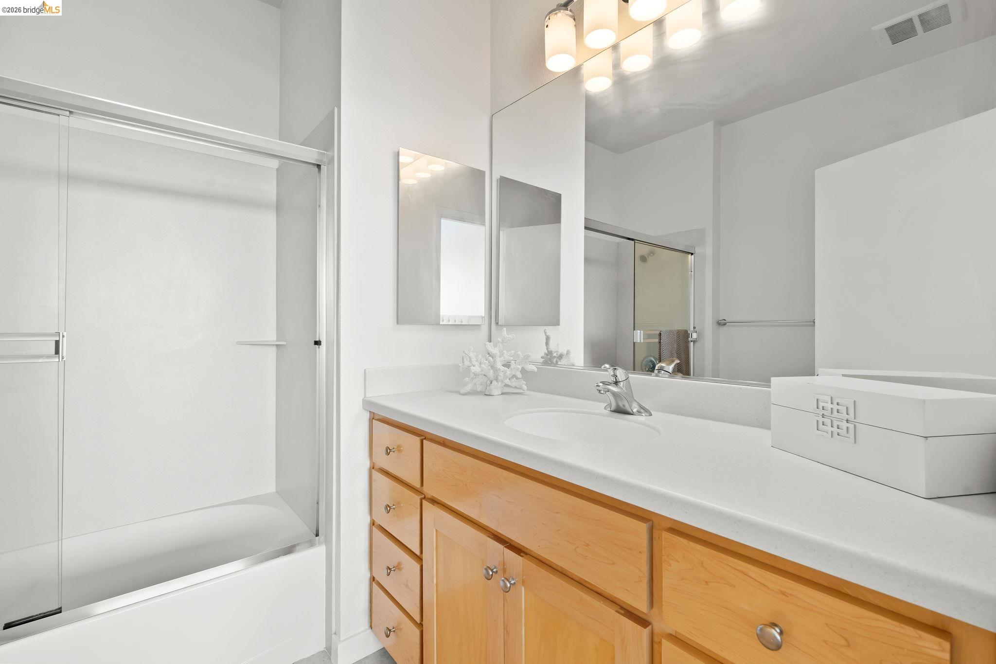 1780 12th Street Oakland, CA 94607 - Photo 17 of 31 a bathroom with a bathtub sink vanity and mirror