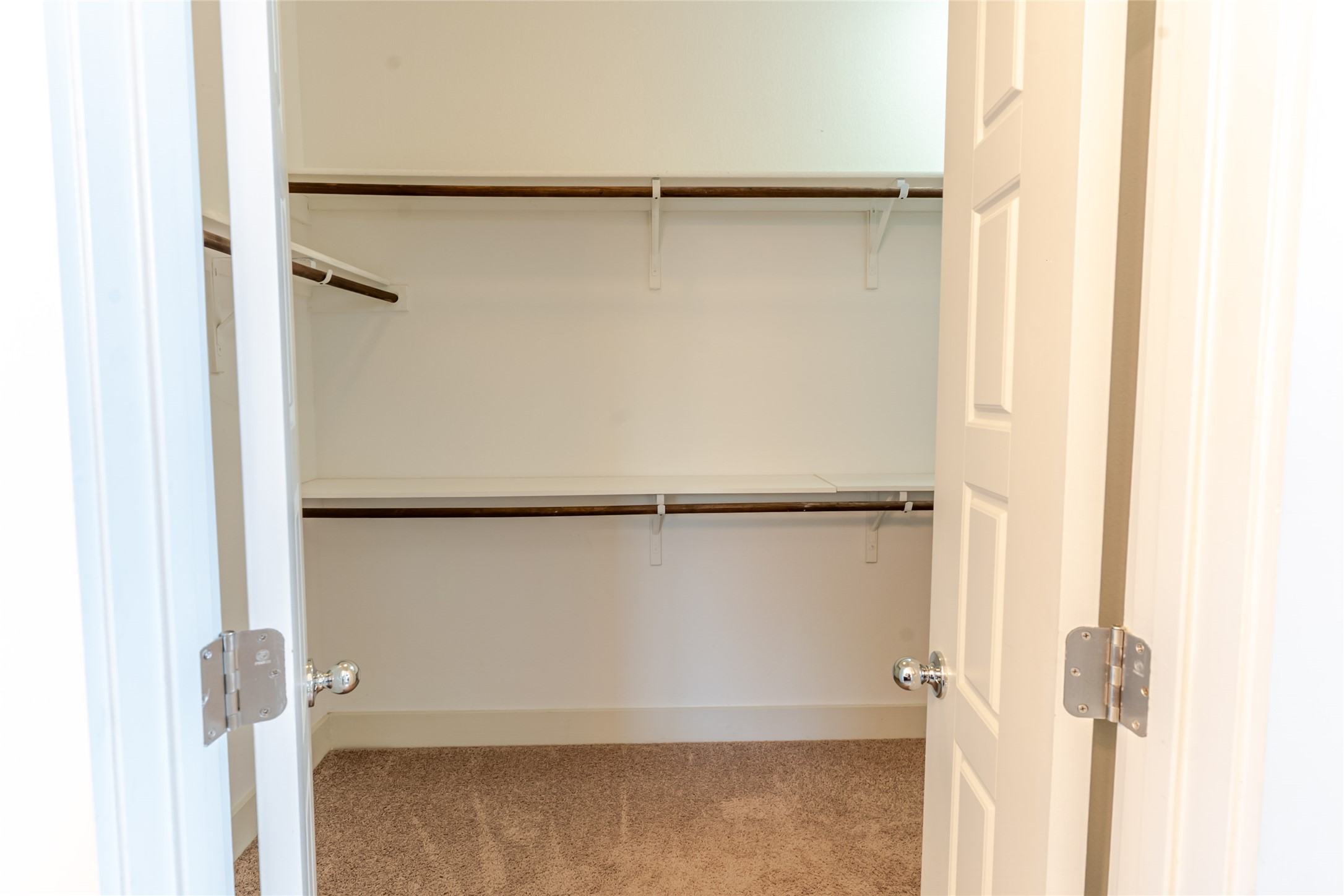1400 Homespun Road Austin, TX 78745 - Photo 26 of 30 Double doors open to reveal structured shelving and soft carpet underfoot.